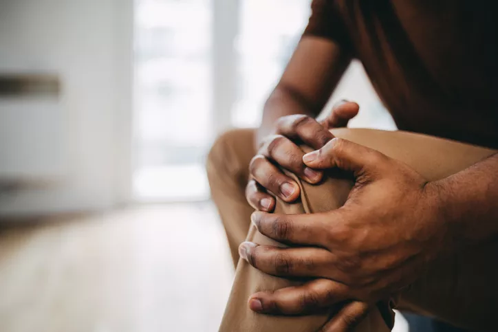 Man holding painful knee